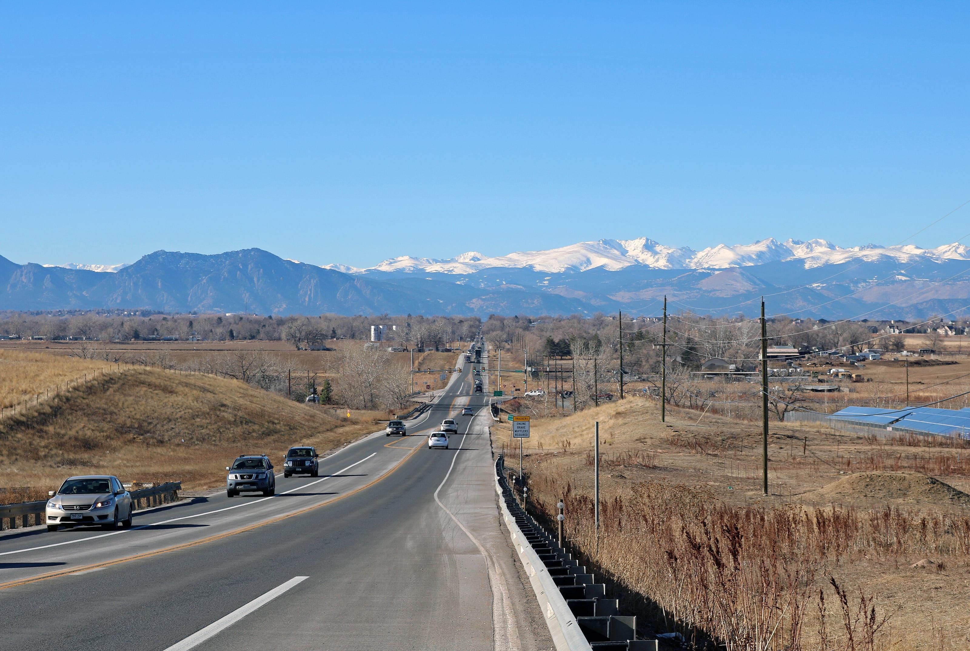Baseline Road running west toward the Front Range, snow on the high peaks under a clear winter sky